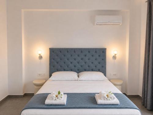 a bedroom with a large bed with towels on it at Haraki Emerald in Haraki