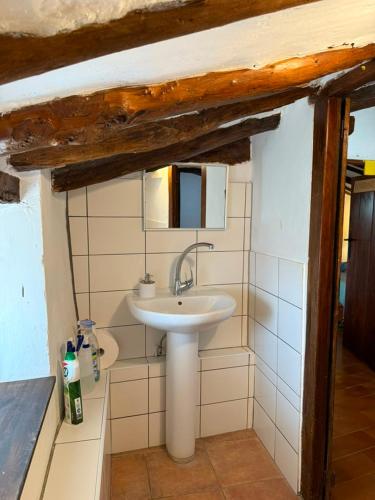 a bathroom with a sink and a mirror at Albergue OasisTrails for pilgrims on Camino de Santiago in Villamayor de Monjardín