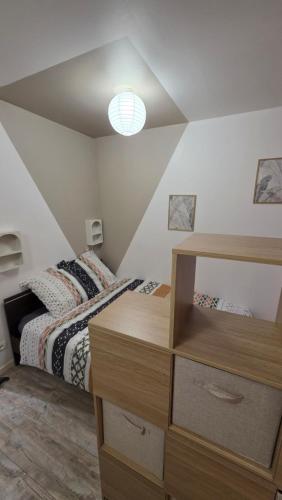 a bedroom with a bed and a dresser in it at Double studio en face a face in Tuchan