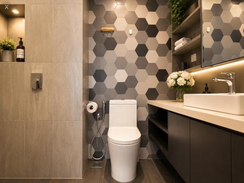 a bathroom with a toilet and a sink at Ceylonz Suites KLCC By KL Tower in Kuala Lumpur