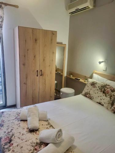 a bedroom with a large bed with towels on it at Barbara Studios in Skala Potamias