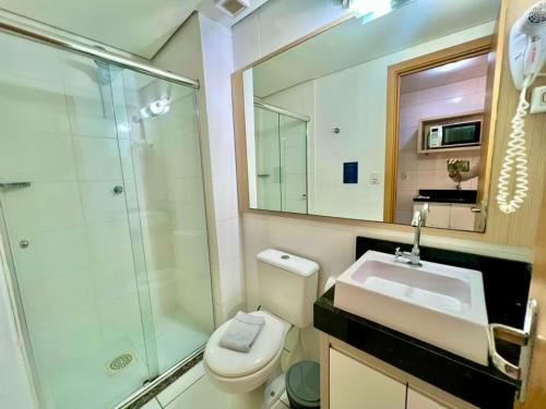 a bathroom with a toilet and a sink and a shower at Executive - 106 No Garage in Caxias do Sul