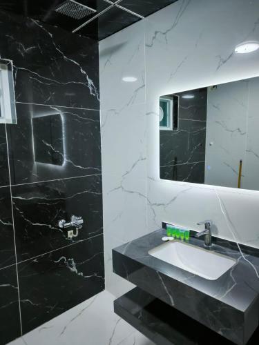 a bathroom with a sink and a mirror at Hotel Ararat in Erbil