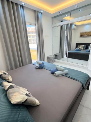 a bedroom with two beds and a large window at Luxury NEW Stylish apartment Bayahibe with pool in Bayahibe