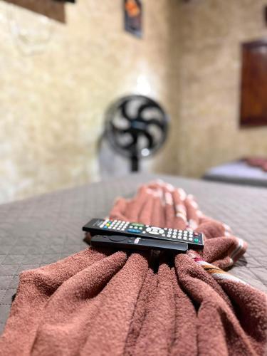 a remote control sitting on top of a pink blanket at Cristales de Antigua Hotel Cristal in Antigua Guatemala