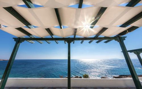 a view of the ocean from a gazebo at Pahivouni Studios & Suites in Donoussa