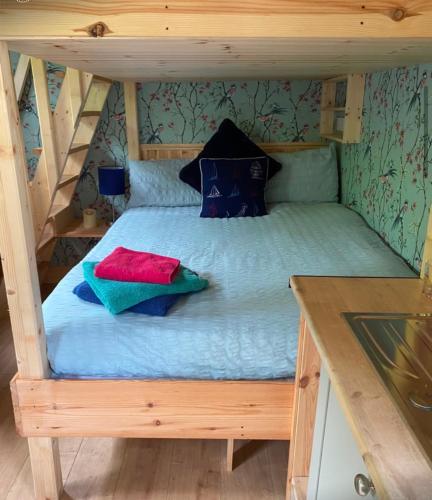 a bed with pillows on it in a room at Meadow Hut in Oughterard