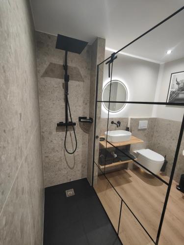 a bathroom with a sink and a mirror at La Brise des Fagnes in Jalhay