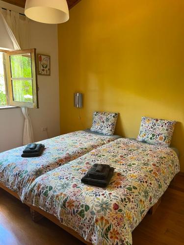 a bedroom with a bed with two towels on it at Quinta dos Lagares in Espadanal