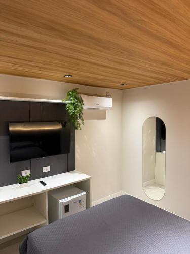a bedroom with a bed and a wall with a ceiling at Vista do Pico in Fernando de Noronha