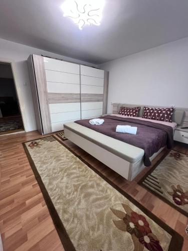 a bedroom with a large bed and a rug at Casa Angela in Râu de Mori