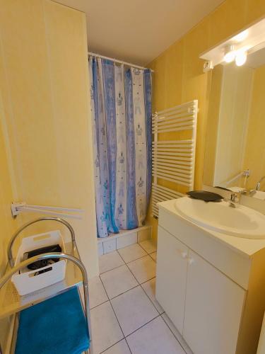 a bathroom with a sink and a toilet and a mirror at Meublé des Capucins - Cocon & Terrasse Privée in Plombières-les-Bains