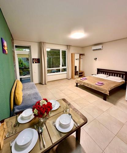 a living room with a bed and a table at Апарт-готель HAPPY in Fontanka