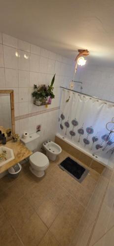 a bathroom with two toilets and a sink at Lodi House in Godoy Cruz