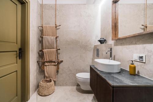 a bathroom with a sink and a toilet at Domek pod Grabami in Gdańsk