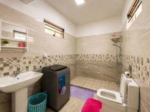 a bathroom with a sink and a toilet and a shower at Ocean view in Pointe aux Biches
