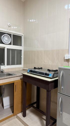 a kitchen with a stove and a counter top at شقه مستقله بالقرب من مطار صلاله in Salalah