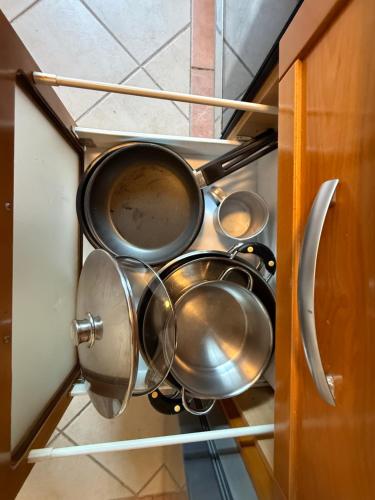 a bunch of pots and pans in a cabinet at Moradia Almorávia in Olhos de Água
