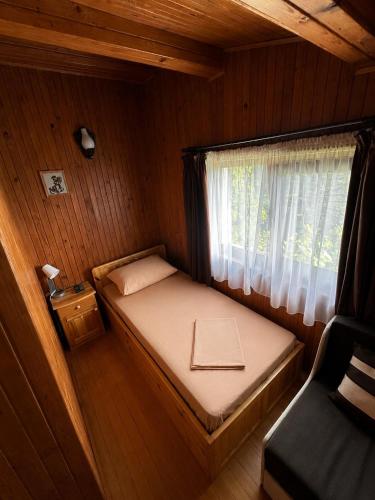 a small bed in a room with a window at Сонита in Yamna