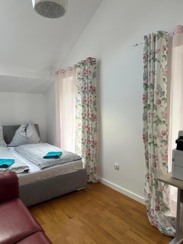 a bedroom with a bed and a window with curtains at Kościelnik Park Apartament in Lubań