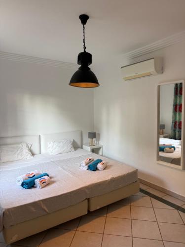 a bedroom with a bed with two dolls on it at Moradia Almorávia in Olhos de Água