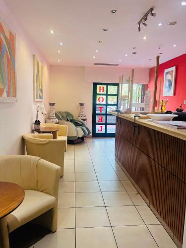 a kitchen with a counter and a table at Hotel Am Flughafen in Cologne