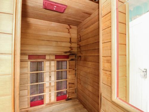 a sauna with wood paneling and a window at Poppies Cottage in Craignure