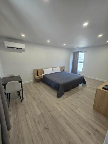 a bedroom with a bed and a desk and a table at Le 2020 Charlevoix in La Malbaie