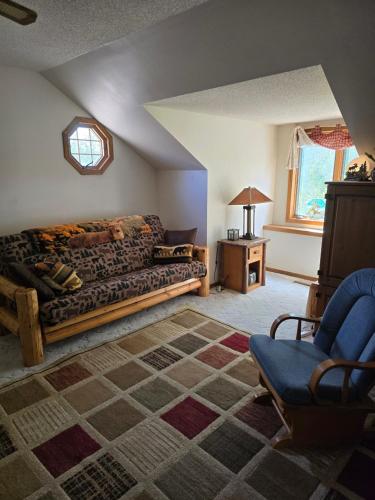a living room with a couch and a chair at Hideaway from the Twin Cities in Houlton