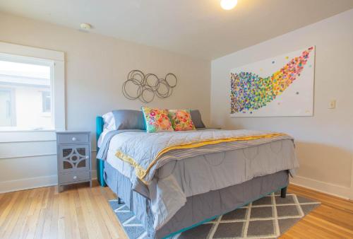 a bedroom with a bed and a painting on the wall at Sleeps 10 Walkable to Everything Pets Game Room in Salida