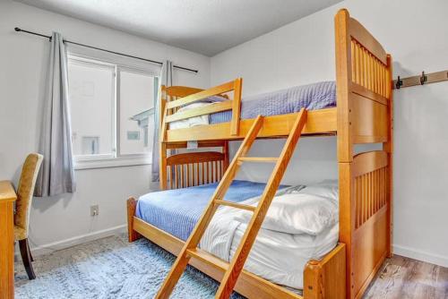 a bedroom with two bunk beds and a window at 4BR Downtown Basecamp - Walk to Everything in Salida