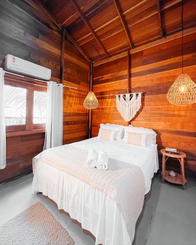 a bedroom with a bed with two towels on it at Vilarejo in Belém