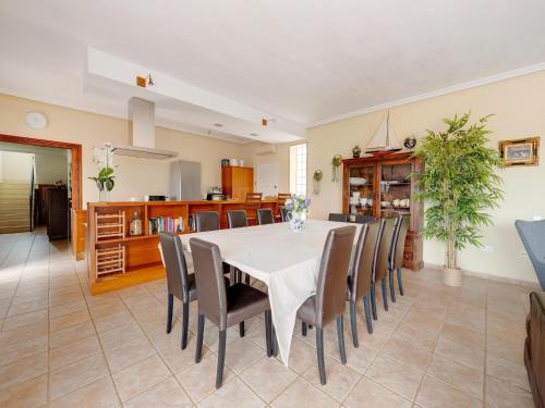 a dining room with a white table and chairs at Villa in El Agar with Private Pool and Beaches in Mina Blanca