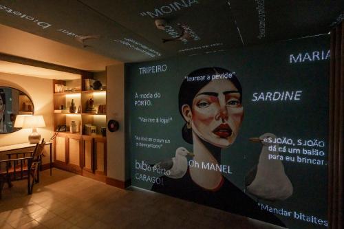 a wall in a room with a poster of a woman at Fontinha Porto, Trademark Collection by Wyndham in Porto