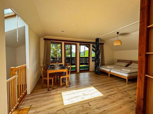 a room with a table and a bed and a bedroom at Apartmány Kořenný in Korěnný
