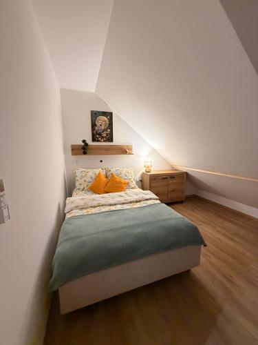 a bedroom with a bed in a attic at W sercu Rynku in Pasym