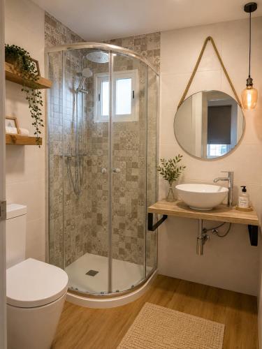 a bathroom with a shower with a toilet and a sink at La casa del papica in Níjar