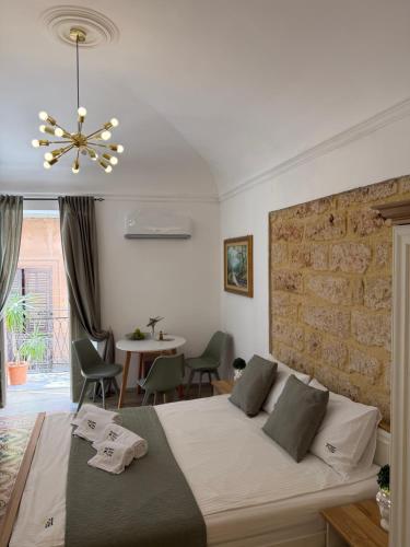 a bedroom with a bed and a brick wall at Appartamenti Tiffany & Timi in Carini