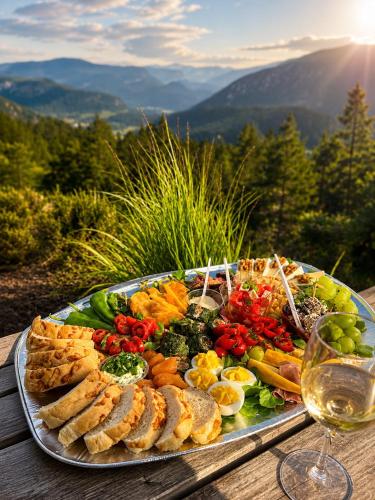 a tray of food on a table with a glass of wine at Birdbox Storehesten in Kvame