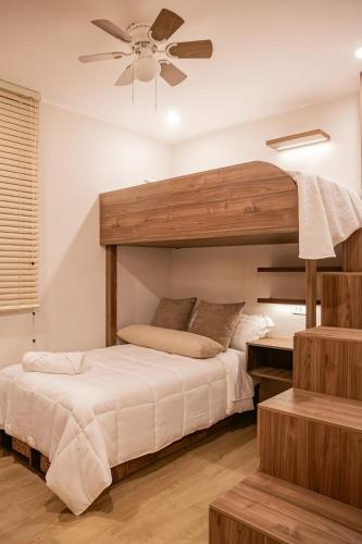 a bedroom with two beds and a ceiling fan at CB Oasis Signature in Ica