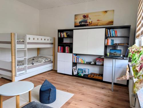 a childs room with a bunk bed and a table at Chez D&D Plus in Eschweiler