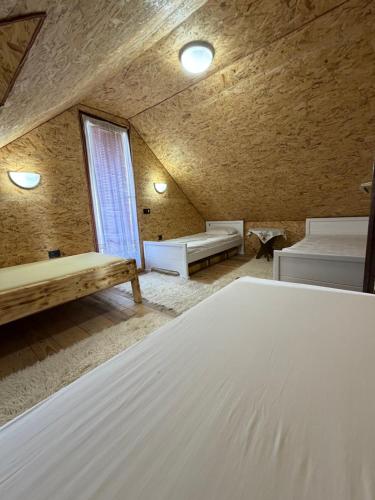 a bedroom with a large white bed in a room at Boravak Tarhaniš Rožaje in Rožaje