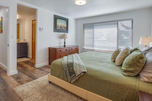 a bedroom with a large bed and a window at Tree-Lined Gold Beach Retreat w/ Multiple Decks! in Gold Beach