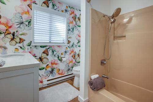 a bathroom with a toilet and butterflies wallpaper at Tree-Lined Gold Beach Retreat w/ Multiple Decks! in Gold Beach