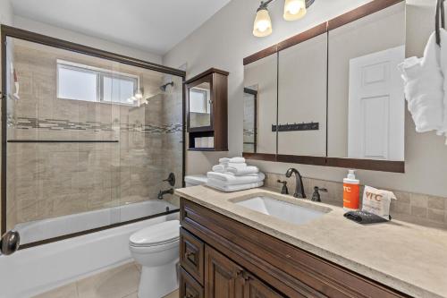 a bathroom with a sink and a toilet and a shower at Riverside Harbor House in Post Falls ID in Post Falls