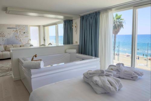 a bathroom with a tub with a view of the beach at Ivory Dimora di Charme in Terracina