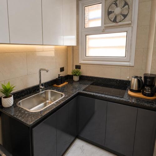 a kitchen counter with a sink and a window at Sunrise View K8 Apartments in Hurghada