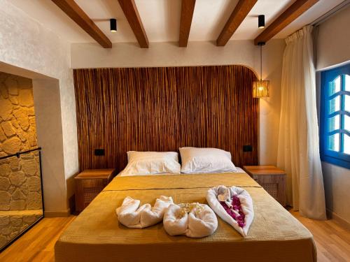 a bedroom with a bed with two towels on it at Naama Lofts in Sharm El Sheikh