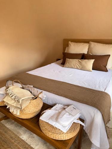 a bedroom with a bed with baskets on it at El campanario Glamping in Jalcomulco