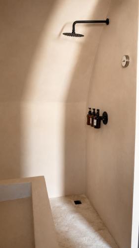 a bathroom with a bath tub and a light on the wall at El campanario Glamping in Jalcomulco